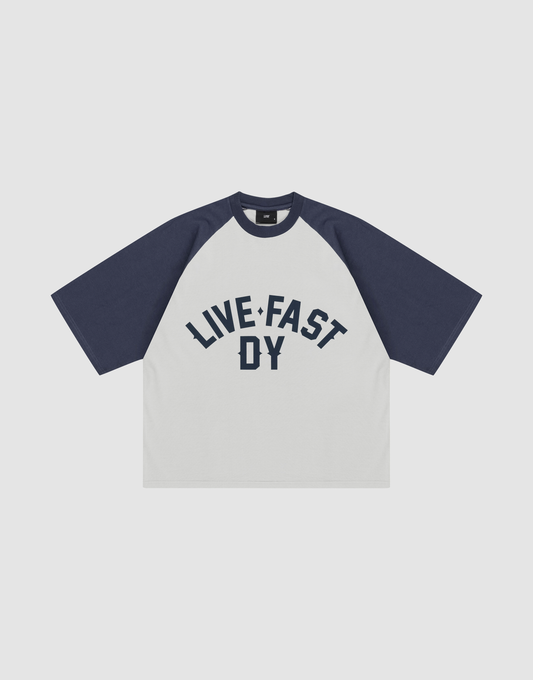 The Live Fast Raglan Tee by LIVE FAST DIE YOUNG features navy Raglan sleeves, a white body, and bold navy "LIVE FAST DY" text on the chest. Made from 100% cotton for comfort. | plain