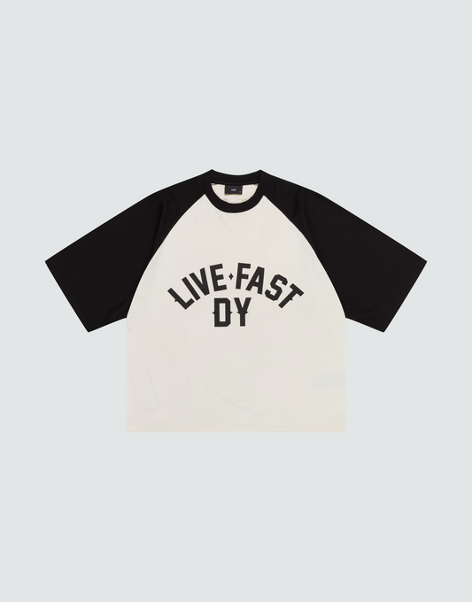 The Live Fast Raglan Tee by LIVE FAST DIE YOUNG is a black and white, boxy oversized raglan t-shirt made from 100% cotton, featuring bold "LIVE FAST DY" text on the front in black capital letters. | plain