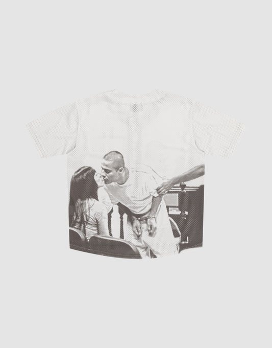 The LFDY Courtroom Jersey by LIVE FAST DIE YOUNG is an oversized white T-shirt with a black-and-white graphic of a handcuffed man kissing a seated woman, and another person’s hand on his shoulder.