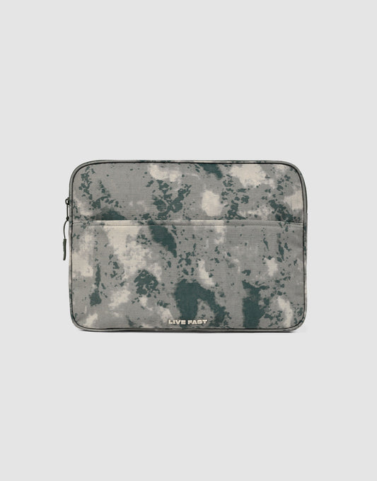 The LFDY Laptop Case by LIVE FAST DIE YOUNG features a gray and green camouflage pattern, a front zip pocket, and a left-side zipper. "LIVE FAST" is printed in white near the bottom center. 