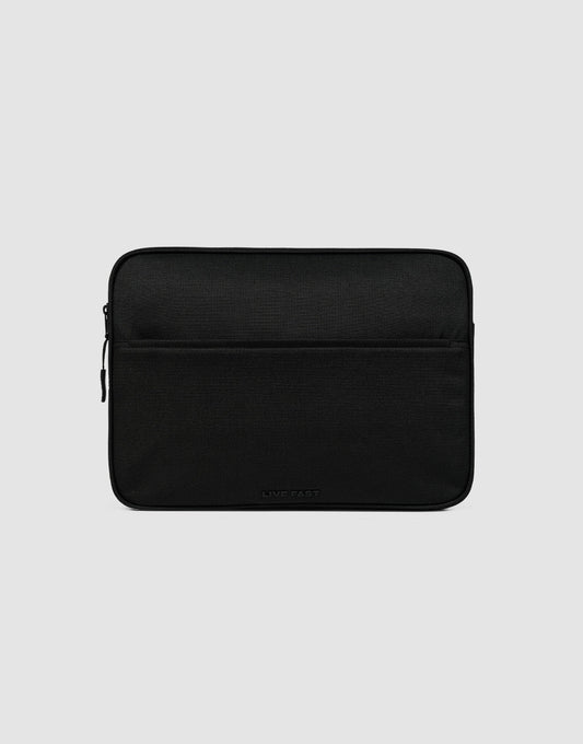 The LFDY Laptop Case by LIVE FAST DIE YOUNG is a black polyester sleeve with a front zippered pocket, shown on a light gray background. It showcases a simple, minimalist design. 