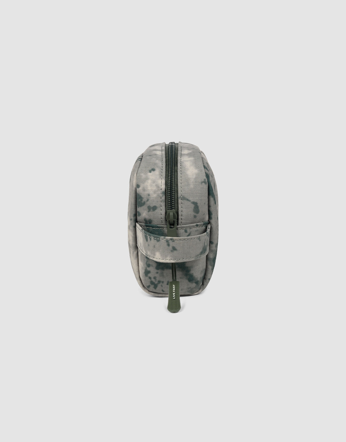 The LFDY Amenity Kit by LIVE FAST DIE YOUNG is a compact 100% polyester pouch in grey digital camo, featuring a top zipper with a green pull and a side handle, shown upright on a plain light background.