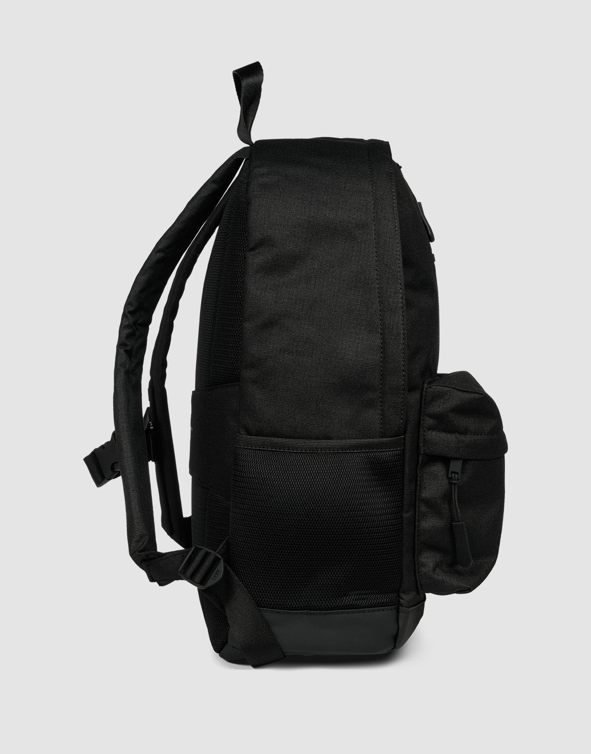 The LFDY Backpack by LIVE FAST DIE YOUNG is shown from the side against a plain light gray background. This black, 19-liter rucksack features adjustable shoulder straps, a mesh side pocket, and a front zippered pocket.