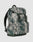 The LFDY Travel Backpack by LIVE FAST DIE YOUNG features a gray and green camo design, front zipper pocket, two buckled straps, side pockets, adjustable shoulder straps, "LIVE FAST" text on the flap, and holds up to 25 liters.