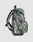 A side view of the LFDY Travel Backpack by LIVE FAST DIE YOUNG, 25L, with green and gray camouflage, adjustable padded shoulder straps, a front pocket, and an external side pocket on a plain light gray background.