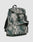 The LFDY Travel Backpack by LIVE FAST DIE YOUNG is a 25L green and gray camo rucksack with front and side pockets, adjustable shoulder straps, top flap closure, and the LIVE FAST brand name on the front.