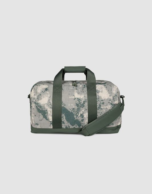 The LFDY Weekender 50 by LIVE FAST DIE YOUNG has dark green handles and strap, a gray-white marbled camo pattern, a spacious 50L compartment, and a removable shoulder strap for versatile use.| plain 