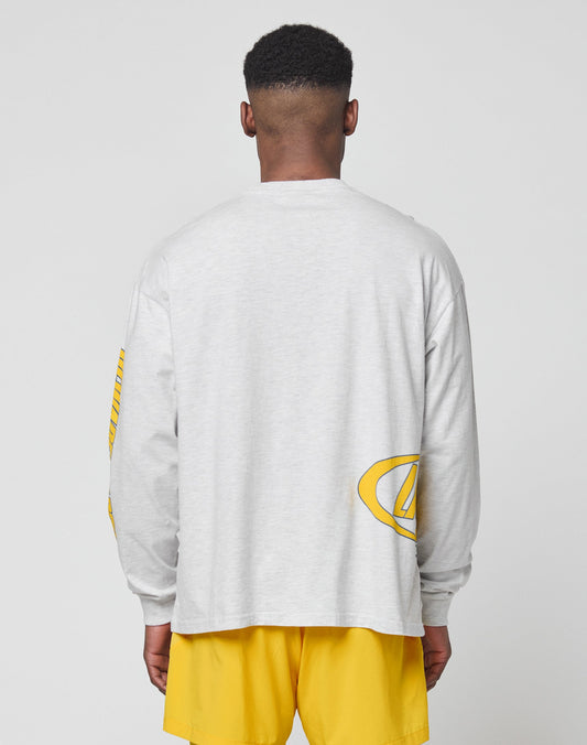 A person with short hair, seen from behind, wears the LIVE FAST DIE YOUNG LFDY Split Sphere Longsleeve in light gray with yellow graphic details and bright yellow shorts, both made of soft Baumwolle, set against a plain light background.