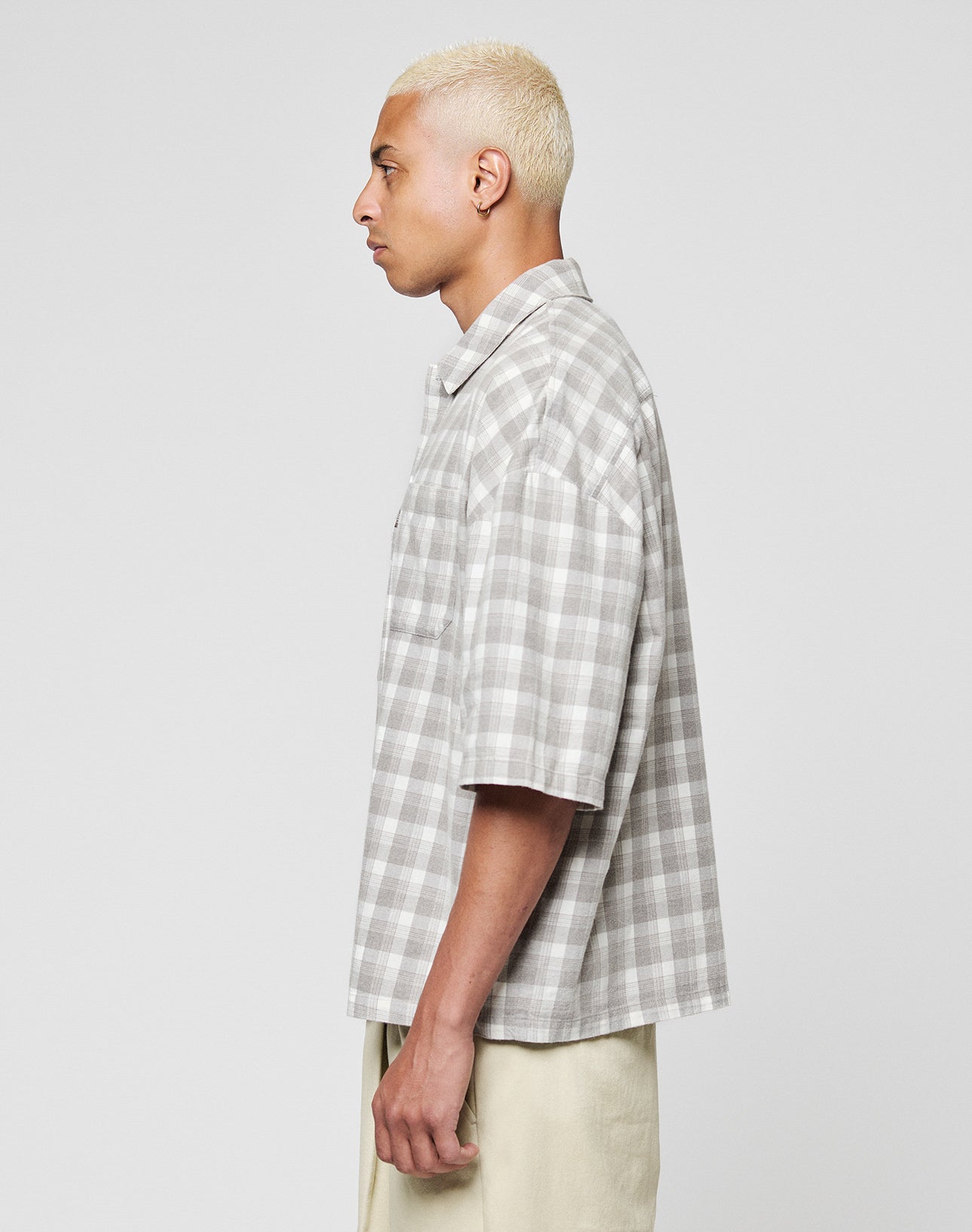 A person with short, bleached blonde hair is shown in profile wearing the LIVE FAST DIE YOUNG LFDY Light Flannel and light pants, featuring subtle branding, against a plain gray background.