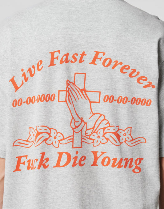 The LFDY Praying Tee by LIVE FAST DIE YOUNG is a gray oversized cotton T-shirt with orange text and a praying hands graphic over a cross with flowers, reading: “Live Fast Forever, 00-00-0000 00-00-0000, Fuck Die Young.”.