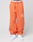 A person wears LFDY 40 Wide Cuff Jogger by LIVE FAST DIE YOUNG in orange with ‘40’ and print on the leg, white waistband with LIVE FAST text, side pockets, and white sneakers, standing against a light background.