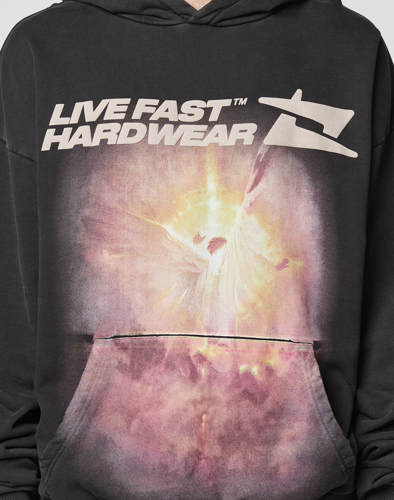 The LFDY Angel Hooded by LIVE FAST DIE YOUNG is a black hoodie with an Oversize Fit, featuring bold LIVE FAST HARDWEAR text and an abstract glowing figure graphic on the front pocket area. Made from 100% Baumwolle for premium comfort.