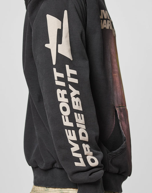 A person wears the LFDY Angel Hooded by LIVE FAST DIE YOUNG, an oversize black 100% cotton hoodie with bold white “LIVE FOR IT OR DIE BY IT” text, plus a graphic and distressed-effect logo on sleeve and chest.