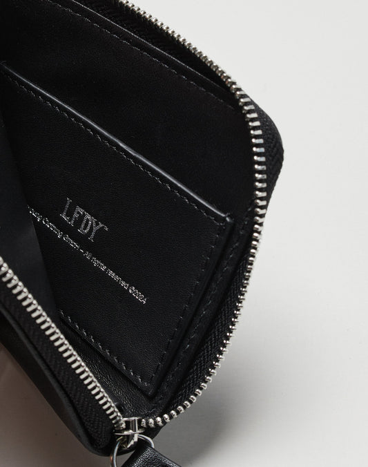 A close-up of the open black Live Fast Wallet by LIVE FAST DIE YOUNG, featuring a visible zip, card slot with LDY in white text, and sleek branding, photographed against a plain white background.