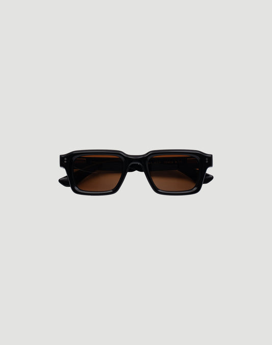 The LFDY x Chimi Shades 03 by LIVE FAST DIE YOUNG are rectangular black acetate sunglasses with thick frames and brown-tinted CR39 lenses offering UV protection. Displayed facing forward on a plain gray background.
