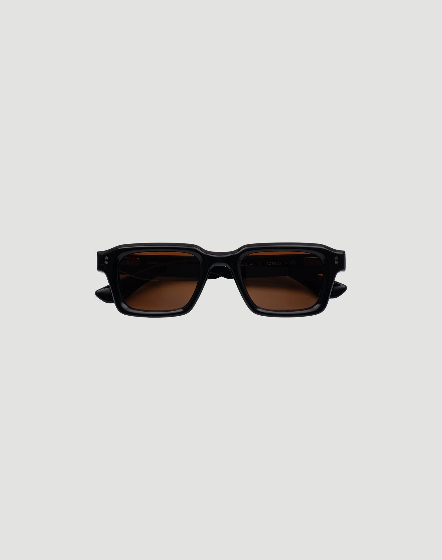 The LFDY x Chimi Shades 03 by LIVE FAST DIE YOUNG are rectangular black acetate sunglasses with thick frames and brown-tinted CR39 lenses offering UV protection. Displayed facing forward on a plain gray background.| plain