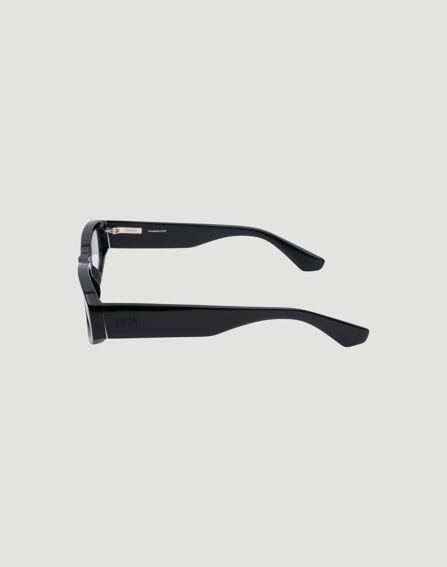 Side view of LIVE FAST DIE YOUNG LFDY x Chimi Shades 09 in black with thick acetate arms, visible hinges and temple tips, set against a plain light gray background. The UV-protected lenses and front are mostly hidden from sight.