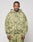 A man with braided hair models the LIVE FAST DIE YOUNG Camo Hooded Zip, featuring an oversize fit and green splatter design, paired with matching pants against a plain white background.