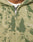 Close-up of the Camo Hooded Zip by LIVE FAST DIE YOUNG, a green and beige zip-up hoodie with a splatter pattern, soft cotton feel, oversize fit for comfort, Live embroidered in white on the right chest, and a partially open zipper.