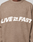 A person wears the Live Fast Boucle Sweater by LIVE FAST DIE YOUNG, an oversized brown knit with "LIVE ★ FAST" in bold white letters across the chest.