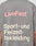 The back of a gray Basic Trademark Tee by LIVE FAST DIE YOUNG features bold pink and white Front- und Backprint text: LiveFast™ Sport- und Freizeitbekleidung. A tattooed arm appears on the right side.