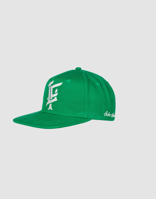 The LF Rhinestone Cap by LIVE FAST DIE YOUNG is a green cotton baseball cap with white embroidered front logo and stylish script text on the side, shown against a plain light gray background.