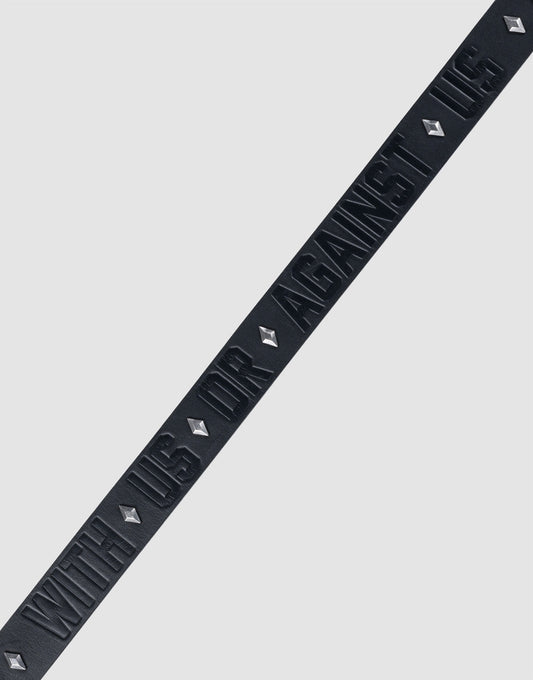 The LFDY Signature Belt by LIVE FAST DIE YOUNG features a black diagonal strip with raised "WITH US OR AGAINST US" text and diamond-shaped Nieten, all set against a plain light gray background.