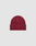 The LIVE FAST DIE YOUNG Rib Knit Beanie is maroon, one size, with a ribbed knit design, folded brim, and a small black rectangular flag-label on the side, shown against a plain light gray background.