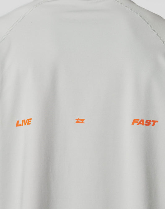 The back of the LFDY Sports Longsleeve by LIVE FAST DIE YOUNG features flatlock seams and LIVE and FAST in orange capitals, split by a small orange star. Oversize fit in light gray adds extra comfort.