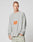 A man with short hair wears the light gray LFDY Sports Longsleeve by LIVE FAST DIE YOUNG, featuring Raglan sleeves and an orange LIVE FAST graphic, paired with light pants. He stands against a plain, light background, looking to the side.