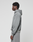 A person stands in profile against a light background, wearing the LIVE FAST DIE YOUNG Basic Evidence Hooded in gray with matching pants. The hoodie features a loose, oversized fit and a faded look, with hands resting by their sides.