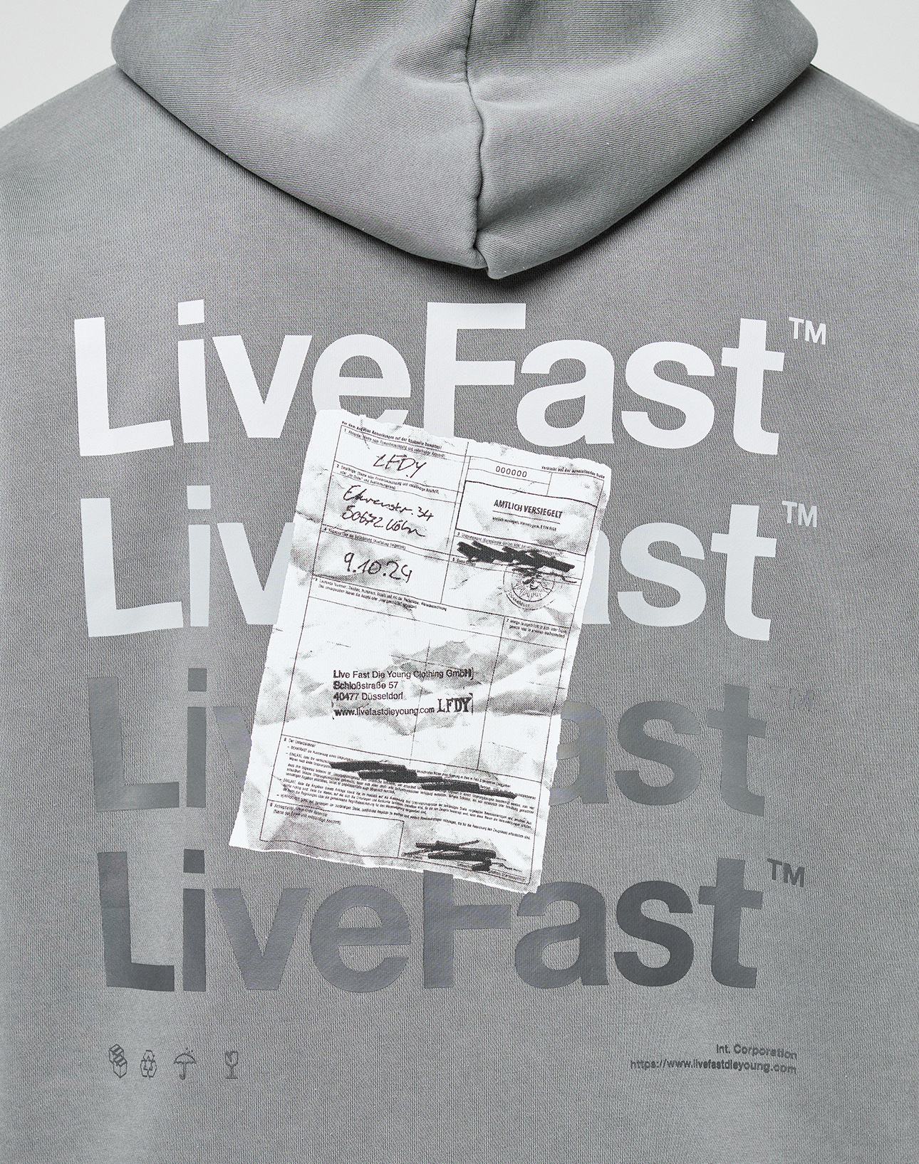 The Basic Evidence Hooded by LIVE FAST DIE YOUNG is a grey hoodie featuring bold white “LiveFast” text and a ripped shipping label on the chest, finished with a subtle faded-look for a worn-in vibe.