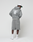 A person in an oversize fit gray Basic Evidence Hooded by LIVE FAST DIE YOUNG, featuring a faded finish and repeated "Live Fast" text on the back, stands facing away. They wear shorts, white sneakers, socks, and a cap against a plain white background.
