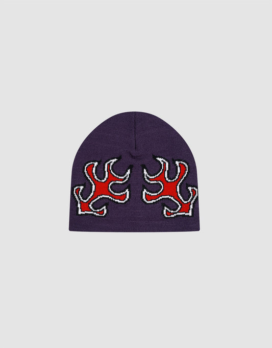 The LFDY Flames Beanie by LIVE FAST DIE YOUNG is a purple polyacryl hat featuring two red Jacquard flame designs outlined in black and white on the front, shown against a plain light gray background.