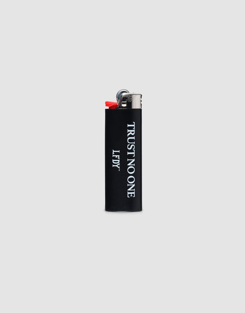 A black LFDY Trust No One Lighter by LIVE FAST DIE YOUNG with "TRUST NO ONE" and "LIEY" in white vertical text, chromefarbene Kappe, set against a plain gray background.