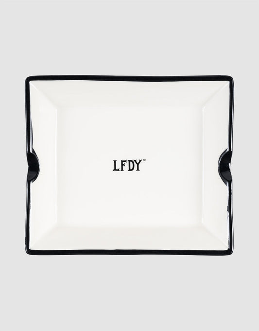 The LFDY Ashtray by LIVE FAST DIE YOUNG is a rectangular white porcelain ashtray with black trim, two notches, and a central black "LFDY" logo. Model: LF2603-20136.
