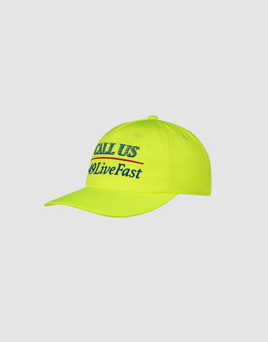 The LFDY Hotline Cap by LIVE FAST DIE YOUNG is a neon yellow unstructured 5-panel cap with “CALL US” and #LiveFast embroidered in blue and black on the front, set against a plain light gray background.