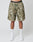 A person wears LIVE FAST DIE YOUNGs Live Fast Nylon Shorts in green camo with side pockets, paired with LIV text white socks, white sneakers, and black waistband underwear reading LIVE FAST. Photo is waist-down against a plain backdrop.