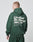 A person wears an oversized dark green LIVE FAST DIE YOUNG Basic 360 Hooded and matching pants, seen from behind. The hoodie shows bold white LiveFast HvySweat 360g/m² text, laundry symbols, front/back print, and is 70% Baumwolle.