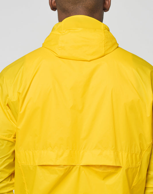 A close-up of a person wearing the LIVE FAST DIE YOUNG Live Fast Performance Running Jacket with Kapuze mit Visor, viewed from behind against a plain background.