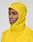 A person models the bright yellow Live Fast Performance Running Jacket by LIVE FAST DIE YOUNG, featuring a visor hood and Regular Fit, standing out against a plain light gray background.