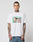 A tattooed man wears the LFDY Sixers Tee from LIVE FAST DIE YOUNG, a white 100% cotton shirt with a colorful two-person car graphic and LIVE FAST text, paired with blue jeans against a plain light background.