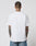 A person with short hair and visible tattoos stands with their back to the camera, wearing the LIVE FAST DIE YOUNG LFDY Sixers Tee in plain white aus 100% Baumwolle and blue jeans in Regular Fit against a light gray background.