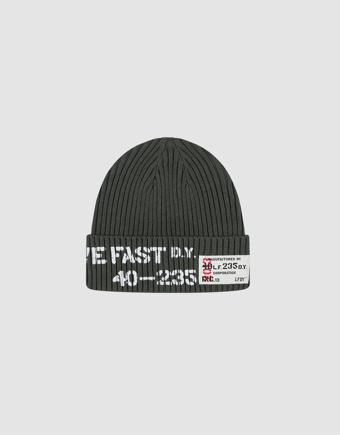 The Live Fast Army Beanie by LIVE FAST DIE YOUNG is a dark gray ribbed knit hat made from 100% Baumwolle, featuring white text and a small frayed web label with numbers and symbols on the folded brim, shown on a plain light gray background.| plain