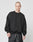 A man with a buzz cut wears the LIVE FAST DIE YOUNG Basic Blank Sweater in oversize black Baumwolle, paired with black drawstring shorts, standing against a white backdrop and gazing slightly to the side with a neutral look.