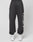 A person wears black LFDY Sphere Jogger pants by LIVE FAST DIE YOUNG, featuring a back pocket, Oversize Fit, and distinctive side logo, paired with white sneakers, standing against a plain white background.