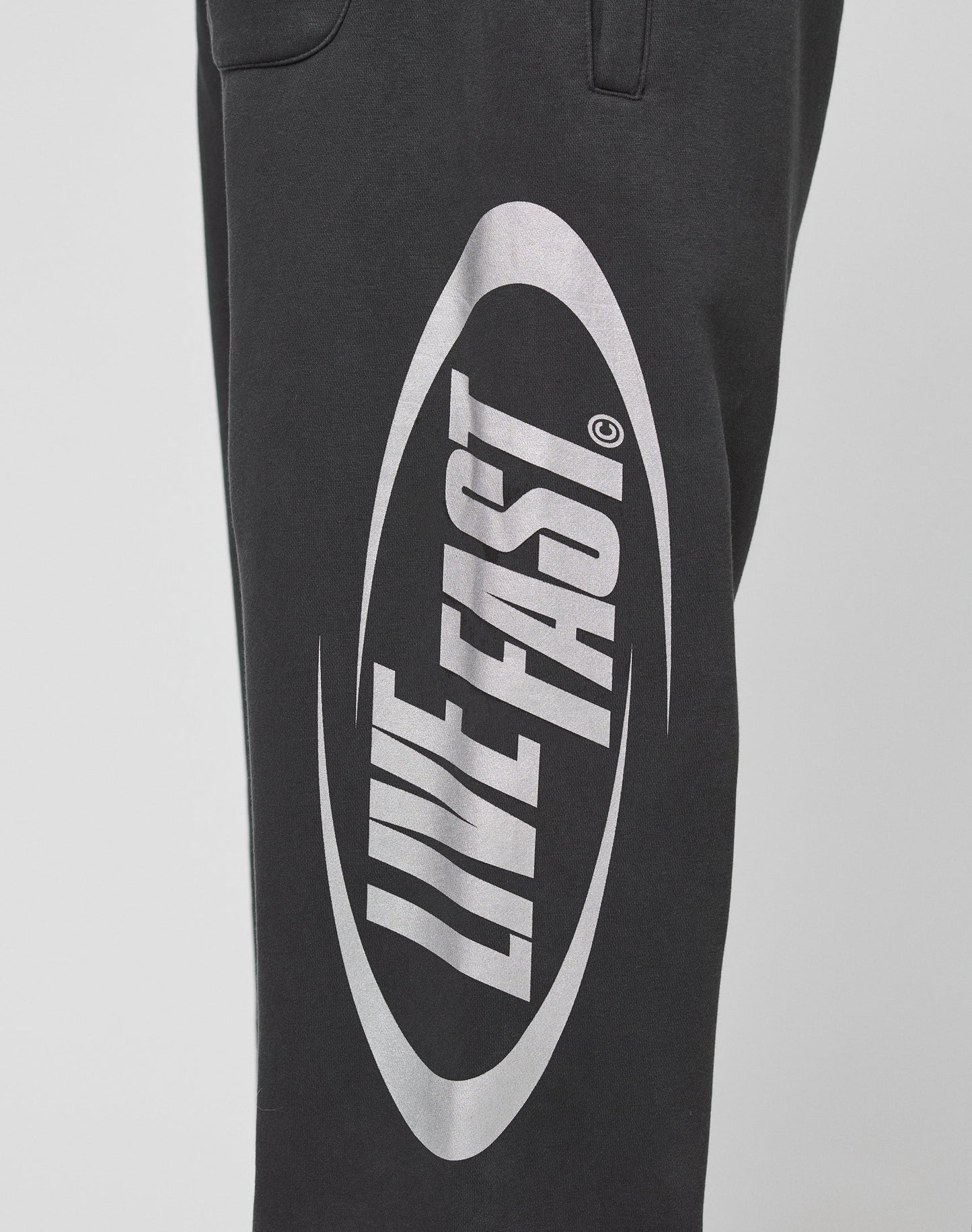 The LFDY Sphere Jogger by LIVE FAST DIE YOUNG features an oversize fit, elastic waistband, and a striking white oval LIVE FAST graphic on the leg. Made from soft cotton for all-day comfort.