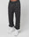 Wearing the LFDY Sphere Jogger by LIVE FAST DIE YOUNG—black cotton sweatpants with an oversize fit, elastic waistband featuring LIVE FAST, and cuffs—paired with white sneakers against a plain white background.