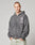 A person with short hair wears a faded gray LIVE FAST DIE YOUNG LFDY Cross Hooded Zip with distress effect and chest graphic, standing hands-in-pockets against a plain light background.
