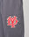 A close-up of gray DY Loose Jogger by LIVE FAST DIE YOUNG, with an elastic waistband and a red and white embroidered LIVE FAST DIE YOUNG patch encircling a stylized design on the upper thigh.